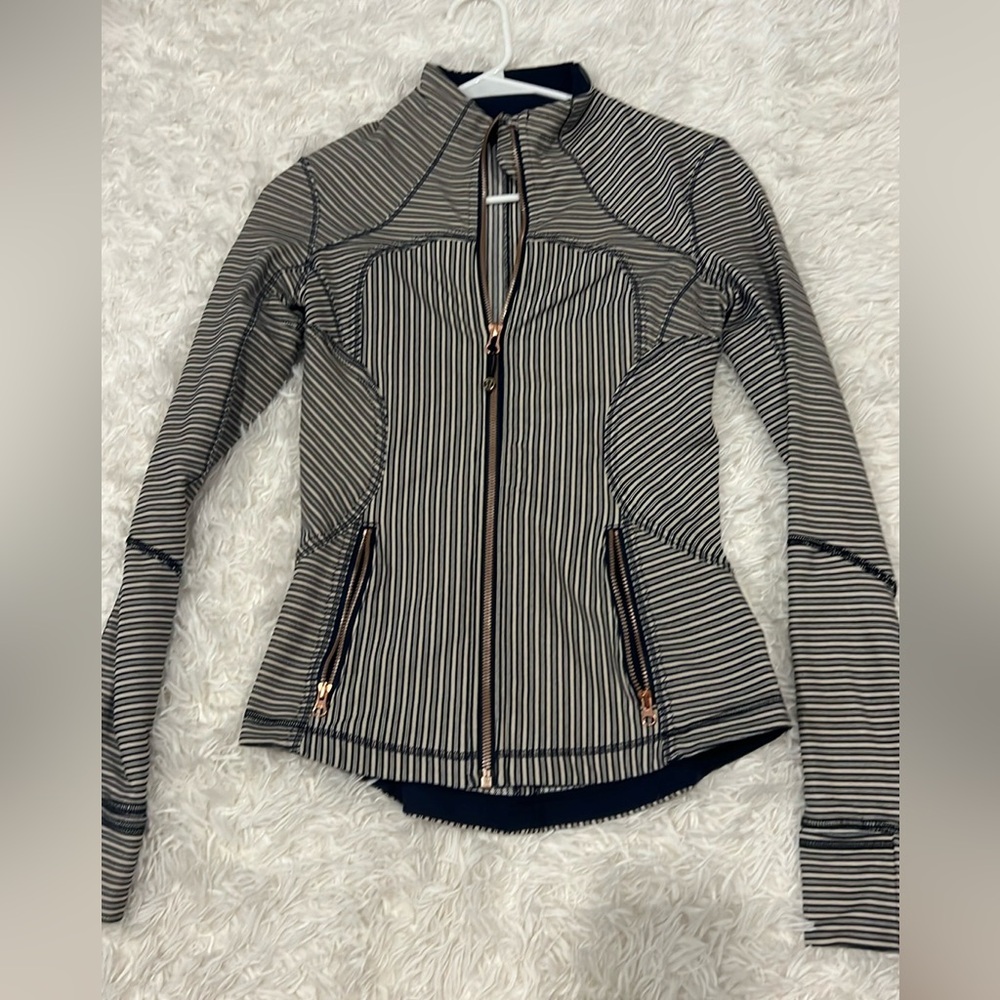 Lululemon jacket. Navy, tanish stripes.